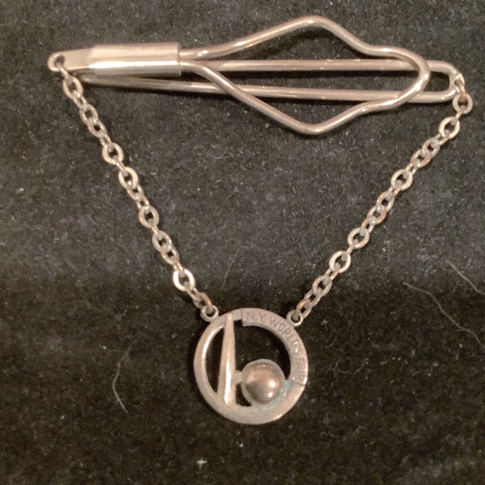 Sterling Silver 1964 NY Worlds Fair pin with the globe symbol of the fair.